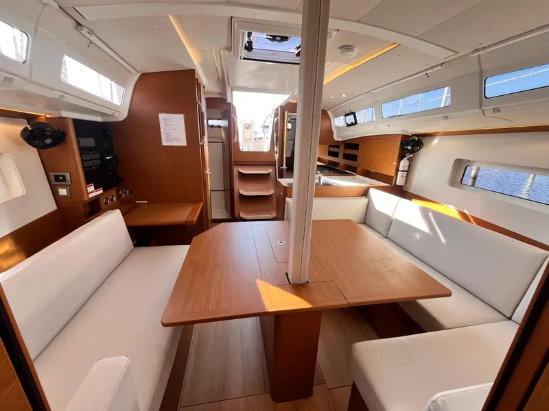 Slide: The Image of 2024 Jeanneau 380 interior with modern wood finish and spacious seating area. - 17