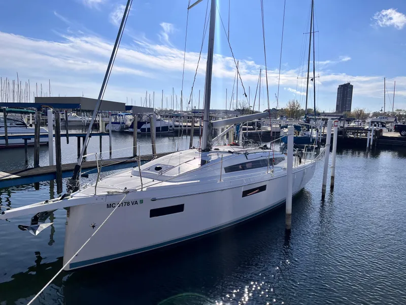 Slide: The Image of 2024 Jeanneau 380 sailboat docked in a marina under a clear blue sky. - 2