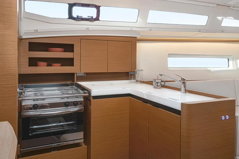 Slide: The Image of Modern kitchen interior of 2024 Jeanneau 380 yacht with sleek cabinetry and stainless steel appliances. - 21