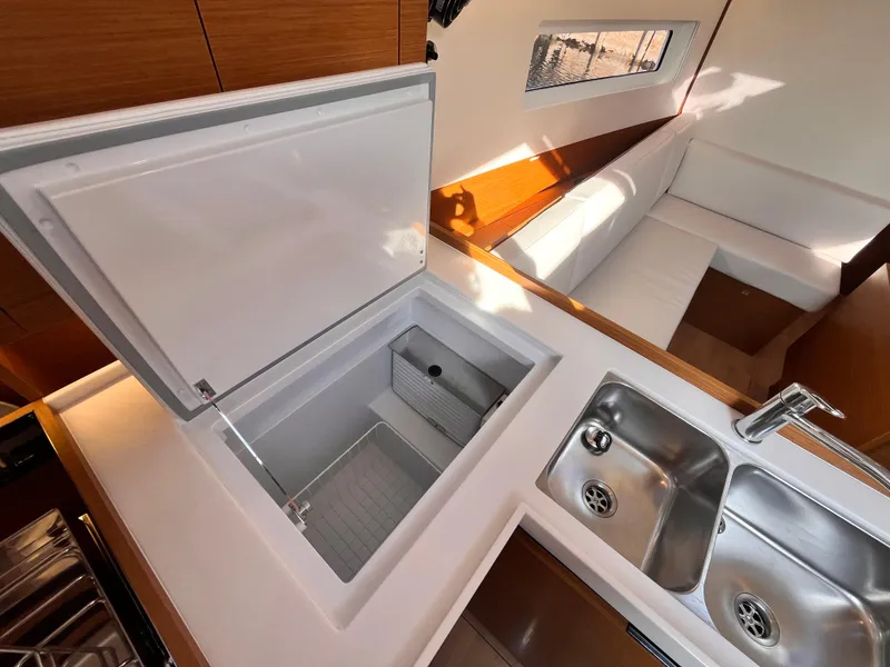 Slide: The Image of Modern kitchen area in 2024 Jeanneau 380 yacht with sink and open storage compartment. - 22