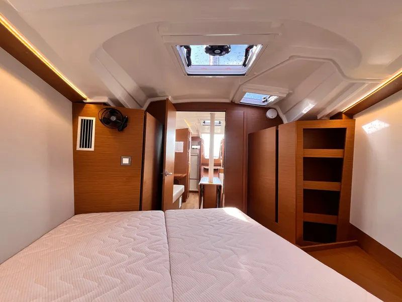 Slide: The Image of 2024 Jeanneau 380 interior cabin with modern wood finish and skylight. - 27