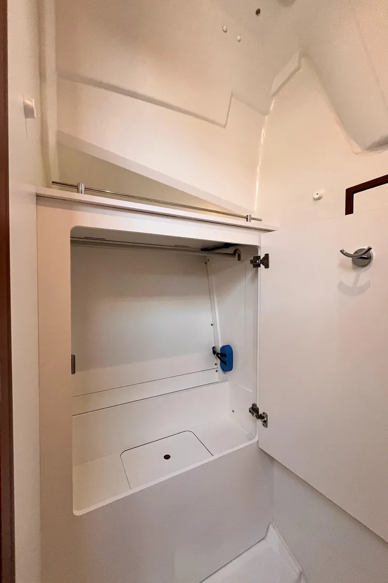 Slide: The Image of 2024 Jeanneau 380 interior storage compartment with white finish and modern design. - 31