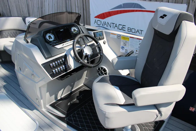 Slide: The Image of 2026 Starcraft SLS 3 Q DH boat helm with modern controls and comfortable captain's chair. - 11