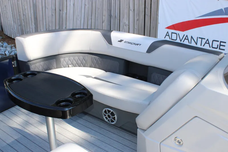 Slide: The Image of Luxurious seating area on 2026 Starcraft SLS 3 Q DH boat with table and cup holders. - 13