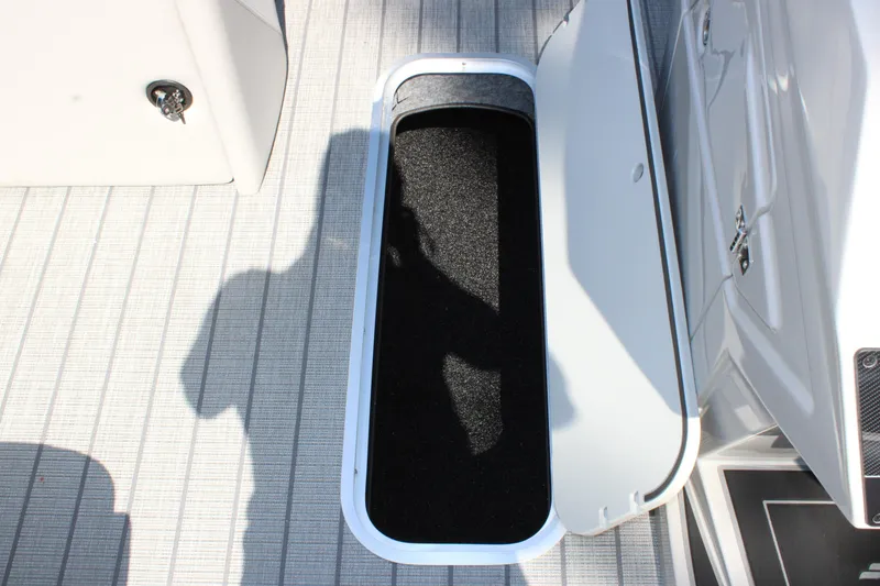 Slide: The Image of Open storage compartment on 2026 Starcraft SLS 3 Q DH boat deck. - 15