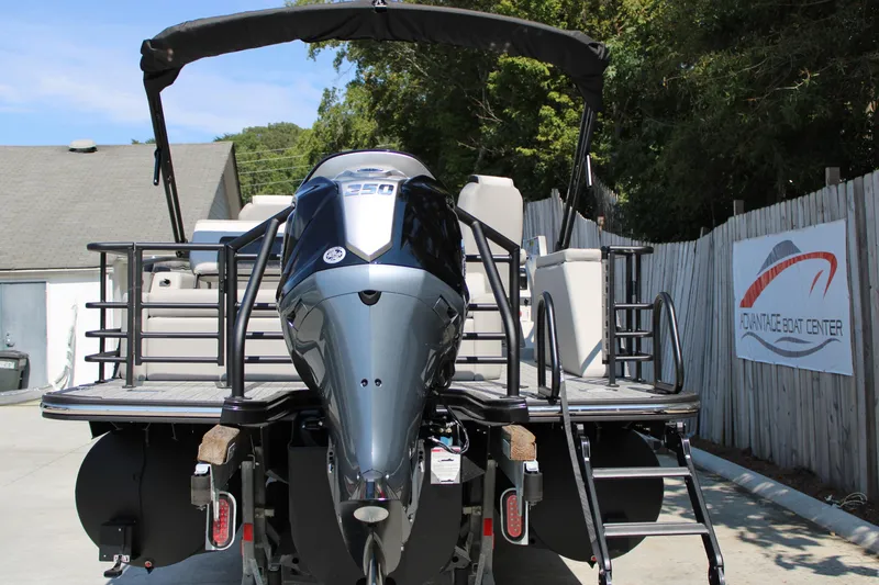 Slide: The Image of 2026 Starcraft SLS 3 Q DH boat with powerful outboard motor, displayed at a boat center. - 4