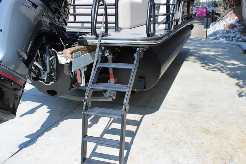 Slide: The Image of 2026 Starcraft SLS 3 Q DH pontoon boat with ladder and motor detail. - 5