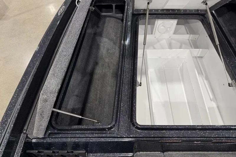Slide: The Image of 2026 Phoenix 721 ZXL boat storage compartments with open lids and hydraulic supports. - 12