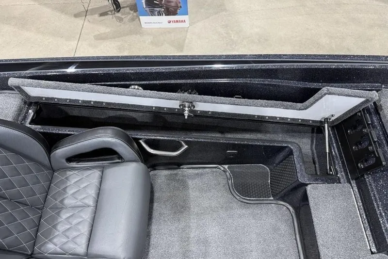 Slide: The Image of 2026 Phoenix 721 ZXL boat interior with open storage compartment and quilted seat design. - 19