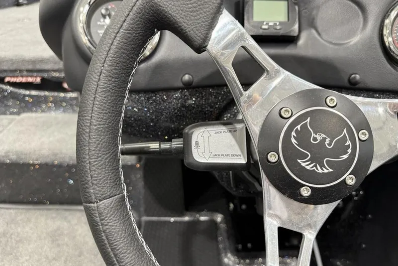 Slide: The Image of Steering wheel of 2026 Phoenix 721 ZXL boat with logo and controls. - 21