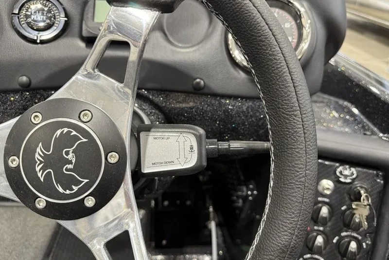 Slide: The Image of Steering wheel of 2026 Phoenix 721 ZXL boat with control panel and logo. - 25