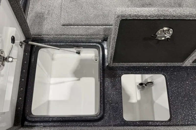 Slide: The Image of Interior compartments of a 2026 Phoenix 721 ZXL boat, featuring storage and latch mechanisms. - 32