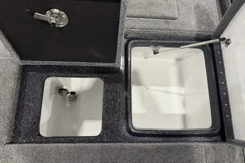 Slide: The Image of 2026 Phoenix 721 ZXL boat storage compartments with secure latches and carpeted interior. - 33