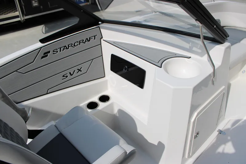 Slide: The Image of 2026 Starcraft SVX 190 OB boat interior with seating, cup holders, and sleek design. - 12