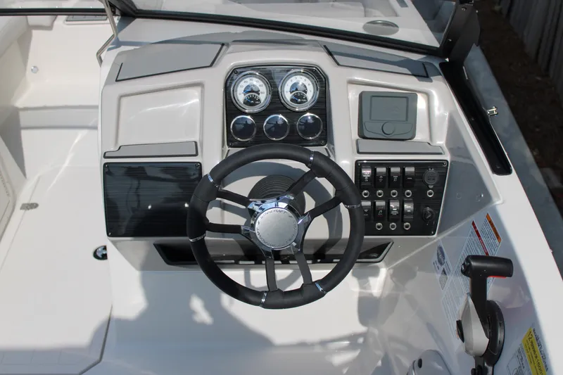 Slide: The Image of 2026 Starcraft SVX 190 OB boat dashboard with steering wheel and control panel. - 8