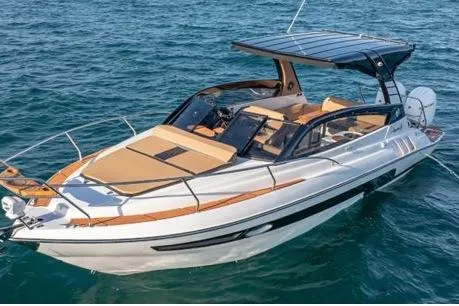 Slide: The Image of 2026 Hanover 305 White and Black Premium Edition boat on open water. - 2