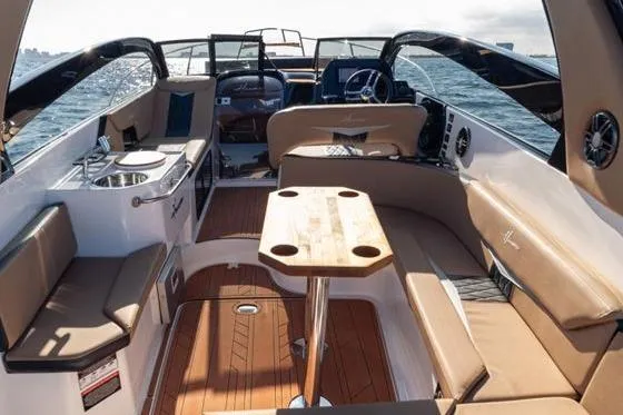 Slide: The Image of Luxurious interior of 2026 Hanover 305 White and Black Premium Edition boat on open water. - 7