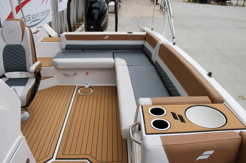 Slide: The Image of 2025 Starcraft SVX 211 OB boat interior with cushioned seating and cup holders. - 10