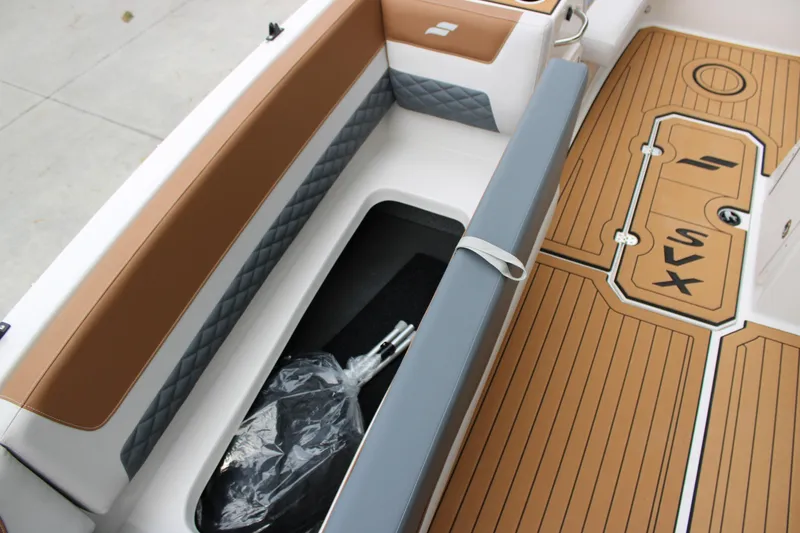 Slide: The Image of 2025 Starcraft SVX 211 OB boat interior with storage compartment and stylish seating. - 12