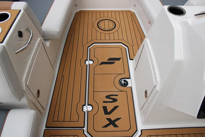 Slide: The Image of 2025 Starcraft SVX 211 OB boat interior with teak-style flooring and storage compartments. - 13