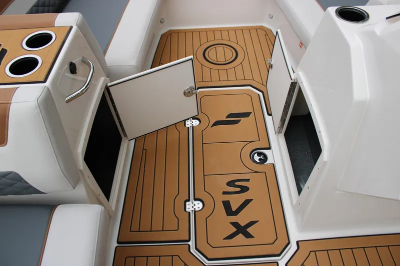 Slide: The Image of Interior of 2025 Starcraft SVX 211 OB boat with open storage compartments and cup holders. - 15