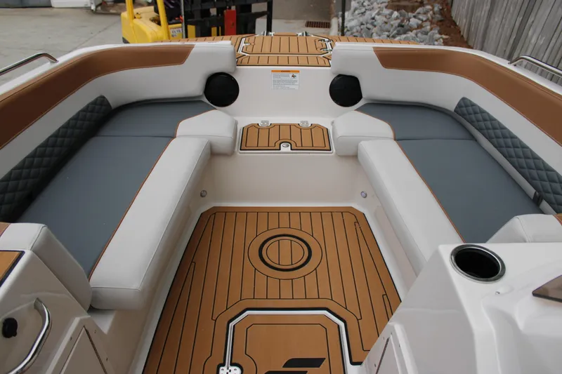 Slide: The Image of 2025 Starcraft SVX 211 OB boat interior with cushioned seating and wood-patterned flooring. - 16