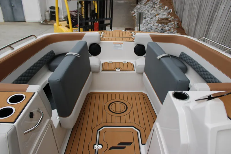 Slide: The Image of 2025 Starcraft SVX 211 OB boat interior with cushioned seating and wood-style flooring. - 17
