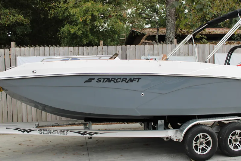 Slide: The Image of 2025 Starcraft SVX 211 OB boat on trailer, side view, outdoors. - 2