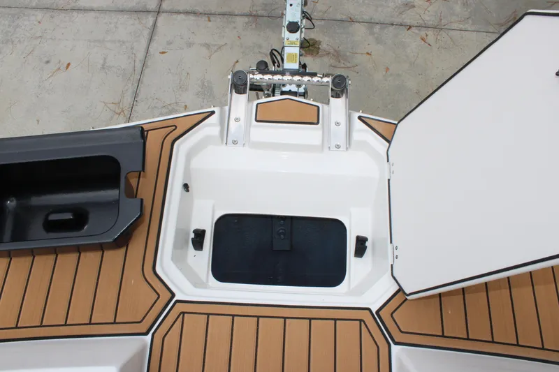 Slide: The Image of 2025 Starcraft SVX 211 OB boat deck with storage compartments and wood-like flooring. - 20