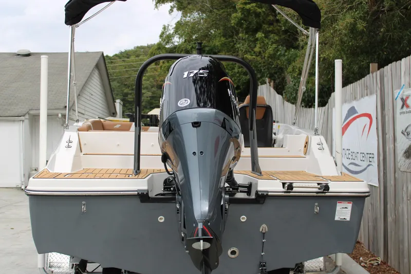 Slide: The Image of 2025 Starcraft SVX 211 OB boat with 175 HP outboard motor, docked outdoors. - 4