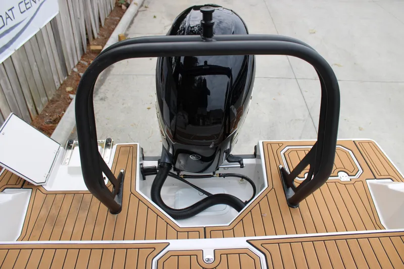 Slide: The Image of 2025 Starcraft SVX 211 OB boat with sleek outboard motor and teak-style deck. - 5