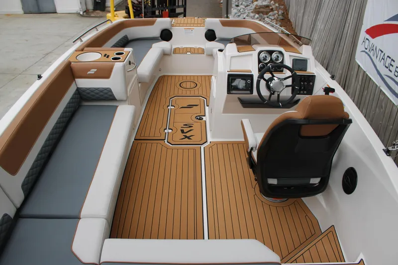 Slide: The Image of 2025 Starcraft SVX 211 OB boat interior with modern seating and sleek dashboard design. - 6