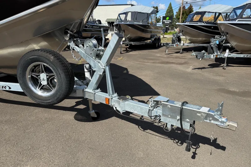 Slide: The Image of Trailer hitch of 2025 Thunder Jet 200 Luxor boat in a dealership lot. - 8