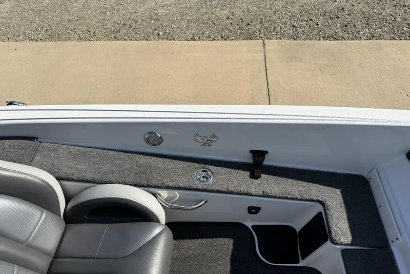 Slide: The Image of Interior of a 2019 Phoenix 618 Pro boat with gray seating and carpeted flooring. - 20