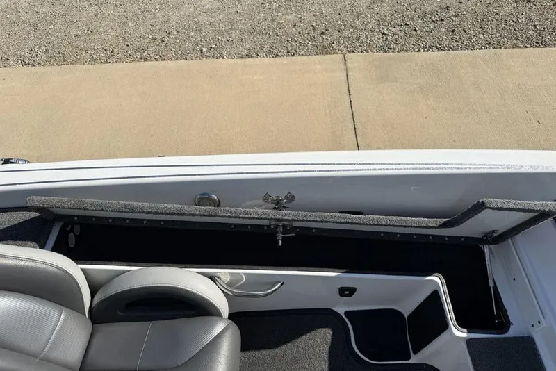 Slide: The Image of 2019 Phoenix 618 Pro boat interior with open storage compartment and seating. - 22