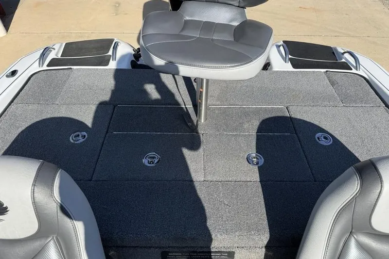 Slide: The Image of 2019 Phoenix 618 Pro boat interior with gray seating and storage compartments. - 23