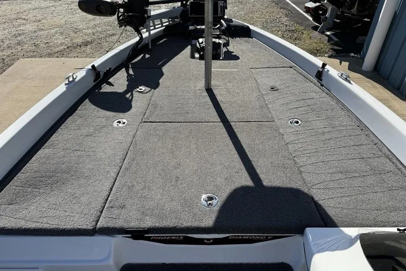 Slide: The Image of 2019 Phoenix 618 Pro boat deck with gray carpet and fishing rod holders. - 9