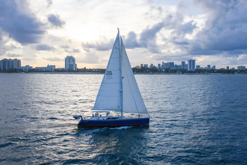 Slide: The Image of Sailing yacht Hylas 63, 2013 model, cruising near city skyline at sunset. - 11