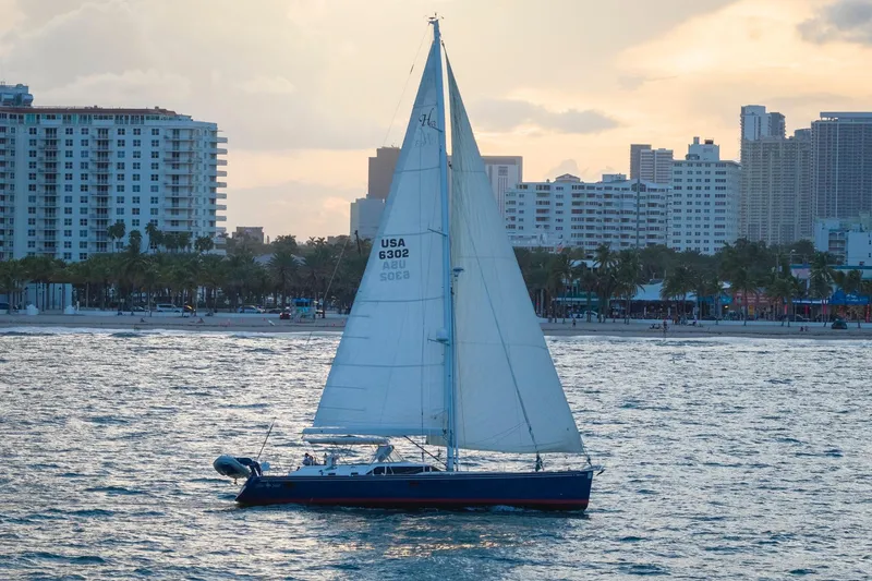 Slide: The Image of Sailing yacht Hylas 63, 2013 model, cruising near a city skyline at sunset. - 12