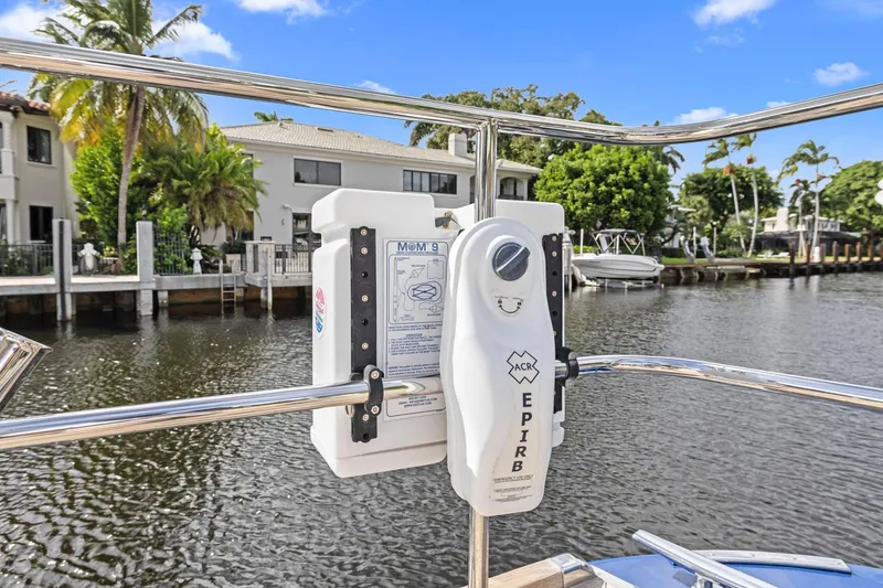 Slide: The Image of EPIRB device on 2013 Hylas 63 yacht, docked by waterfront homes. - 23