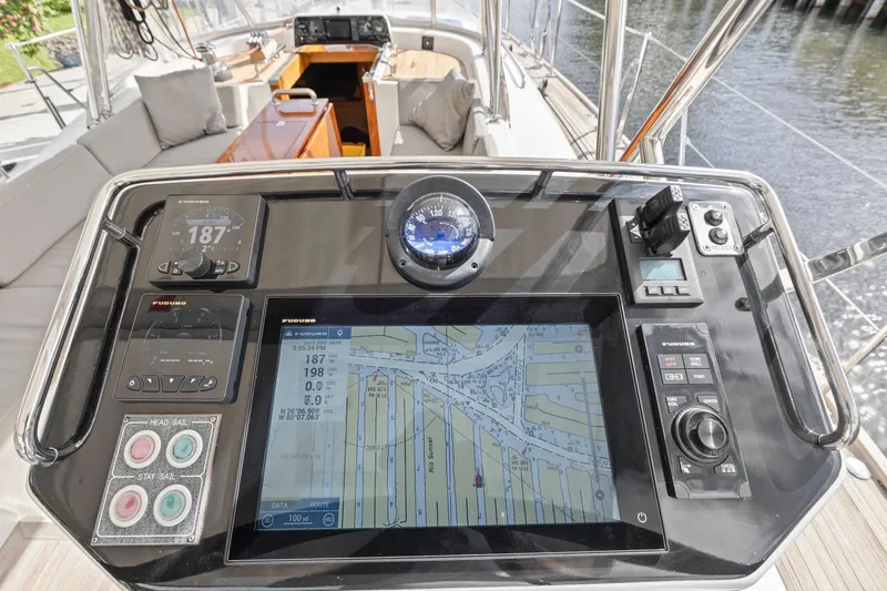 Slide: The Image of Cockpit navigation system on a 2013 Hylas 63 yacht, featuring digital displays and controls. - 27