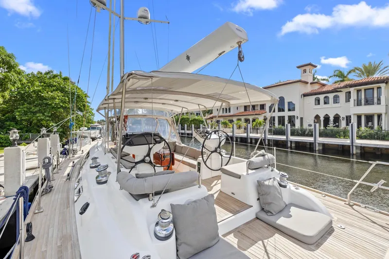 Slide: The Image of Luxurious 2013 Hylas 63 yacht docked by waterfront homes under clear blue sky. - 32