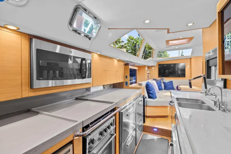 Slide: The Image of Luxurious interior of 2013 Hylas 63 yacht featuring modern kitchen and cozy seating area. - 4
