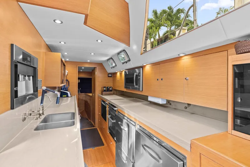 Slide: The Image of Luxurious 2013 Hylas 63 yacht kitchen with modern appliances and sleek wood cabinetry. - 46