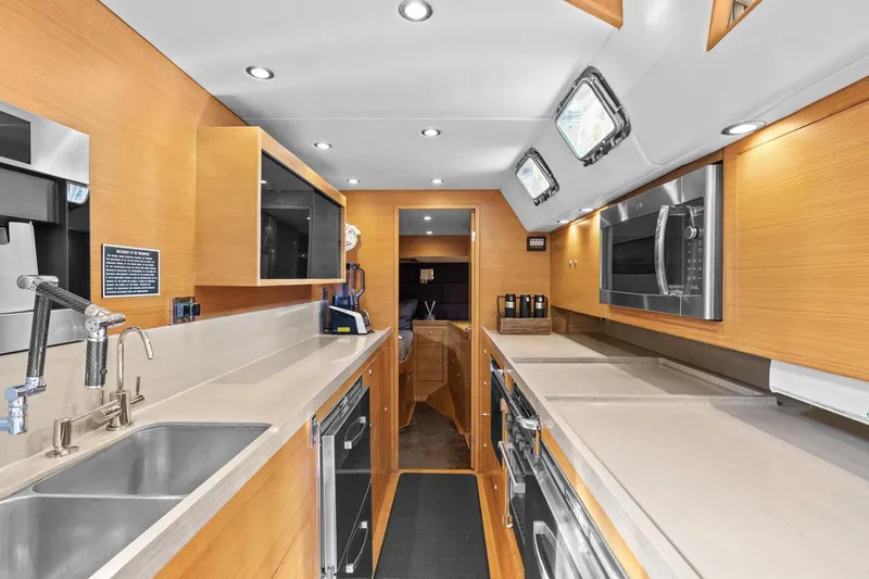 Slide: The Image of Luxurious galley kitchen in a 2013 Hylas 63 yacht, featuring modern appliances and sleek design. - 47