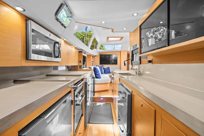 Slide: The Image of Luxurious interior of 2013 Hylas 63 yacht with modern kitchen and seating area. - 49