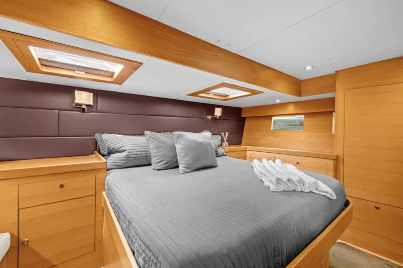 Slide: The Image of Luxurious cabin interior of 2013 Hylas 63 yacht with elegant wood finish and cozy bedding. - 51