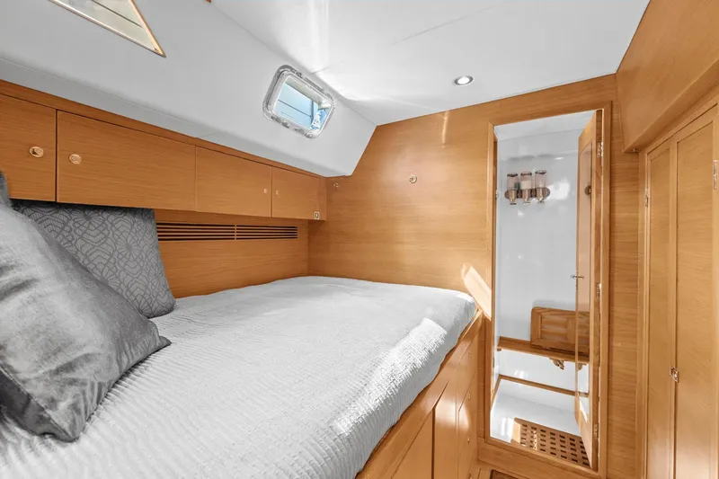 Slide: The Image of Luxurious cabin interior of 2013 Hylas 63 yacht with wooden finish and cozy bedding. - 56