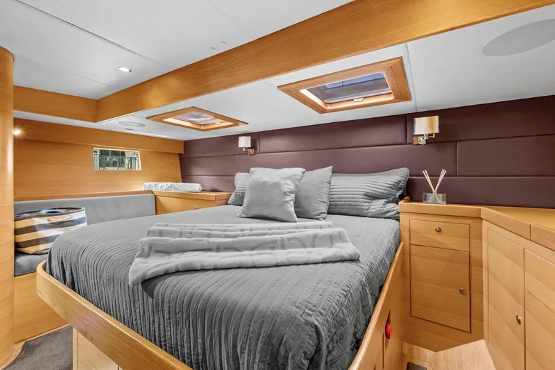Slide: The Image of Luxurious cabin interior of 2013 Hylas 63 yacht with cozy bed and wooden furnishings. - 6