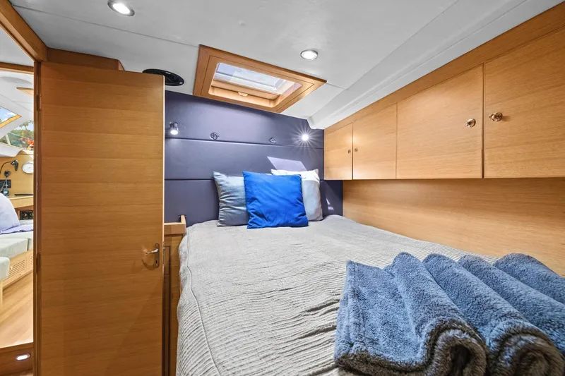 Slide: The Image of Luxurious cabin interior of 2013 Hylas 63 yacht with cozy bedding and wooden cabinetry. - 60